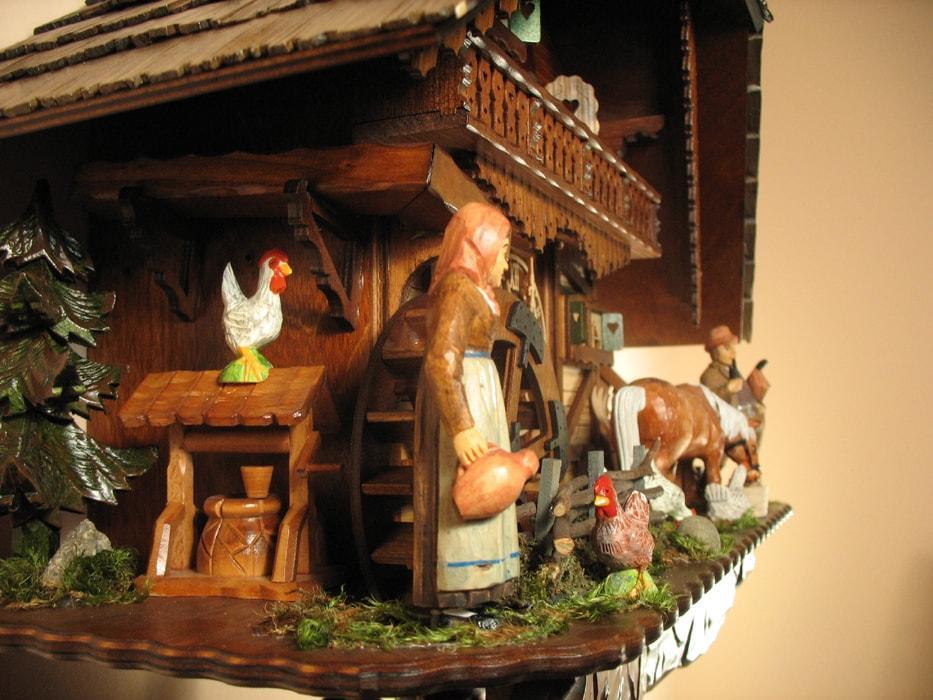 Cuckoo Clock - Rombach & Haas (Romba) Model 8393 FARMER COUPLE 8-Day Black Forest Cuckoo Clock With Intricately Carved Animated Figures, Chalet Style